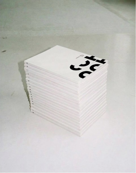 CUT ART GALLERY exhibition catalogues stacked against a concrete background