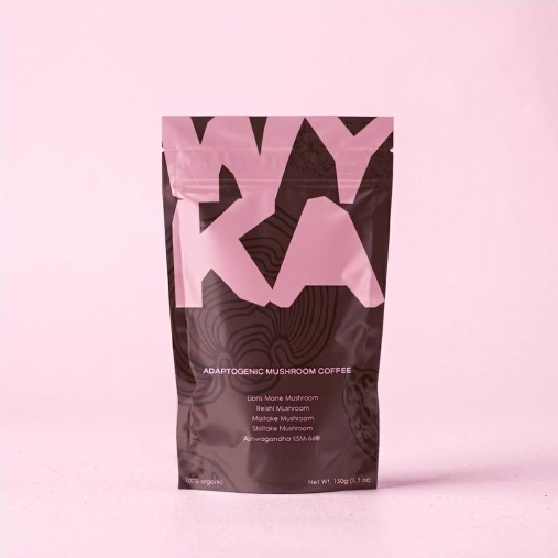 Pink and dark brown WYKA mushroom coffee packaging on a pink background